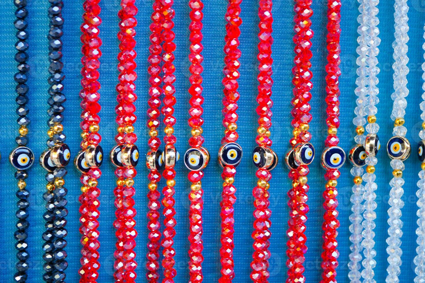 Colorful glass beads displayed for sale at a market stall photo