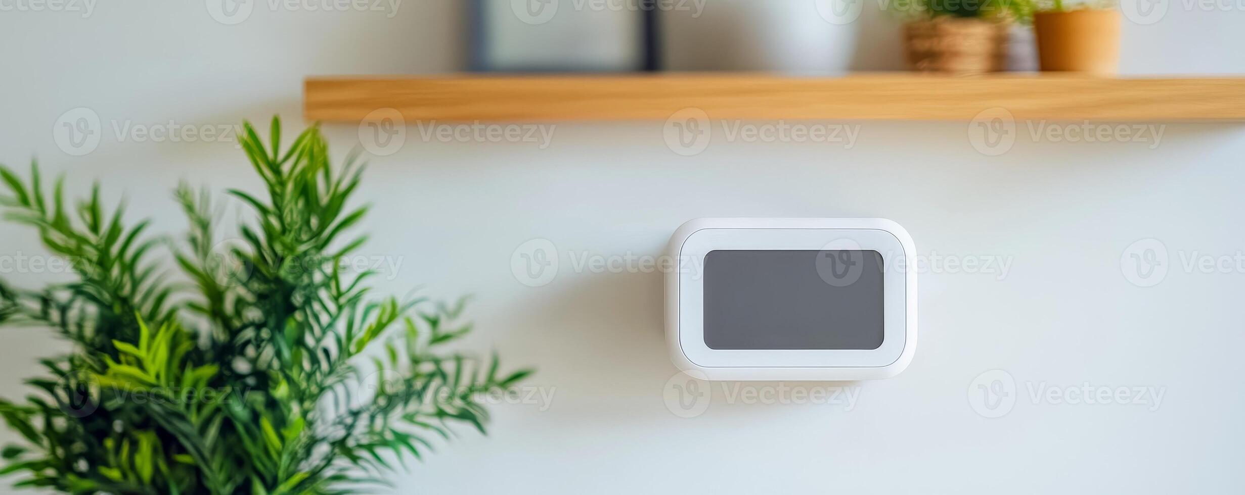 Sustainability of Indoor Air Quality IAQ concept. Smart thermostat mounted on a wall with plants and a wooden shelf in a modern setting. photo