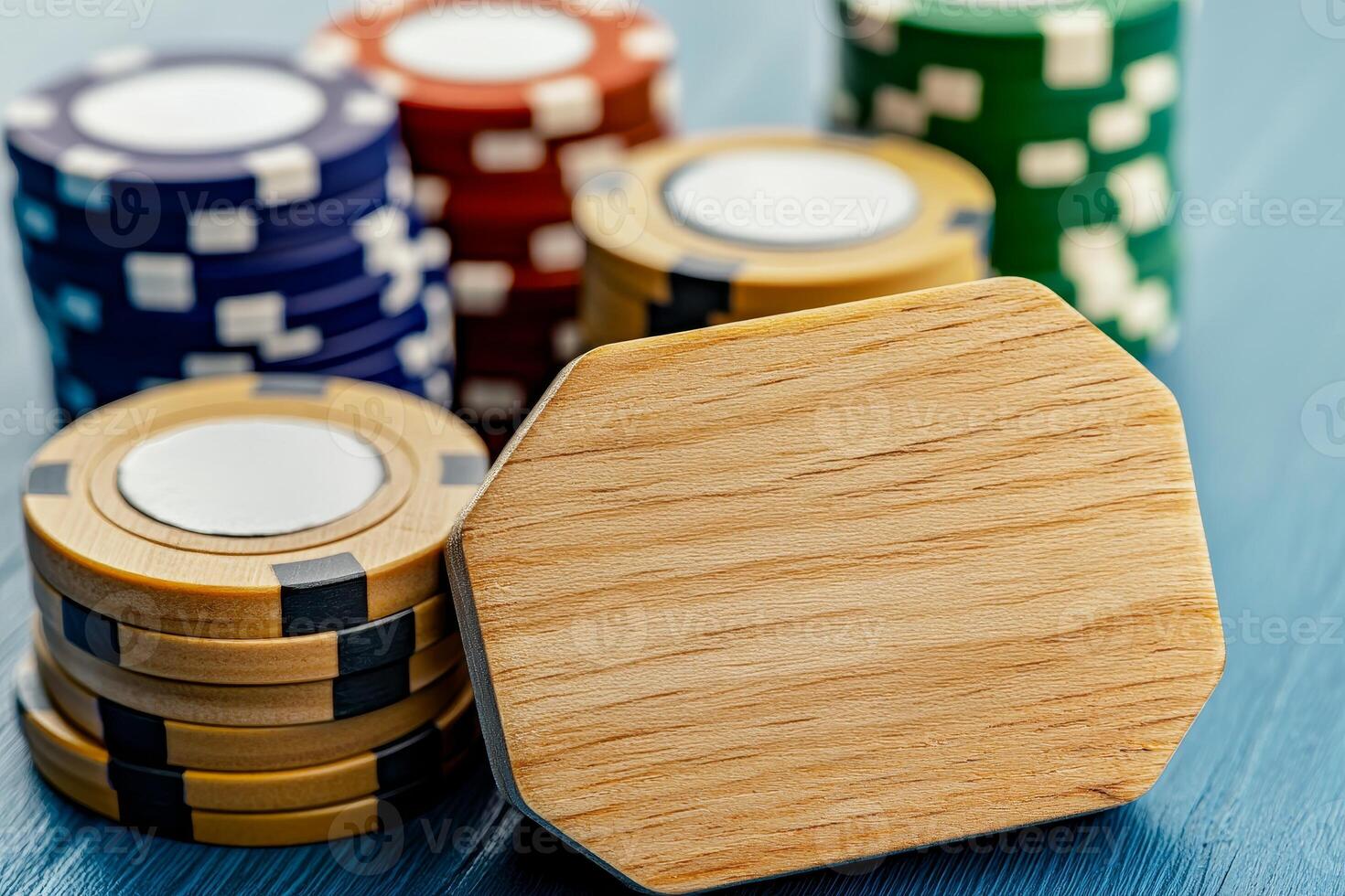 A close-up of poker chips in various colors stacked on a blue surface, showcasing a wooden chip prominently in the foreground. photo