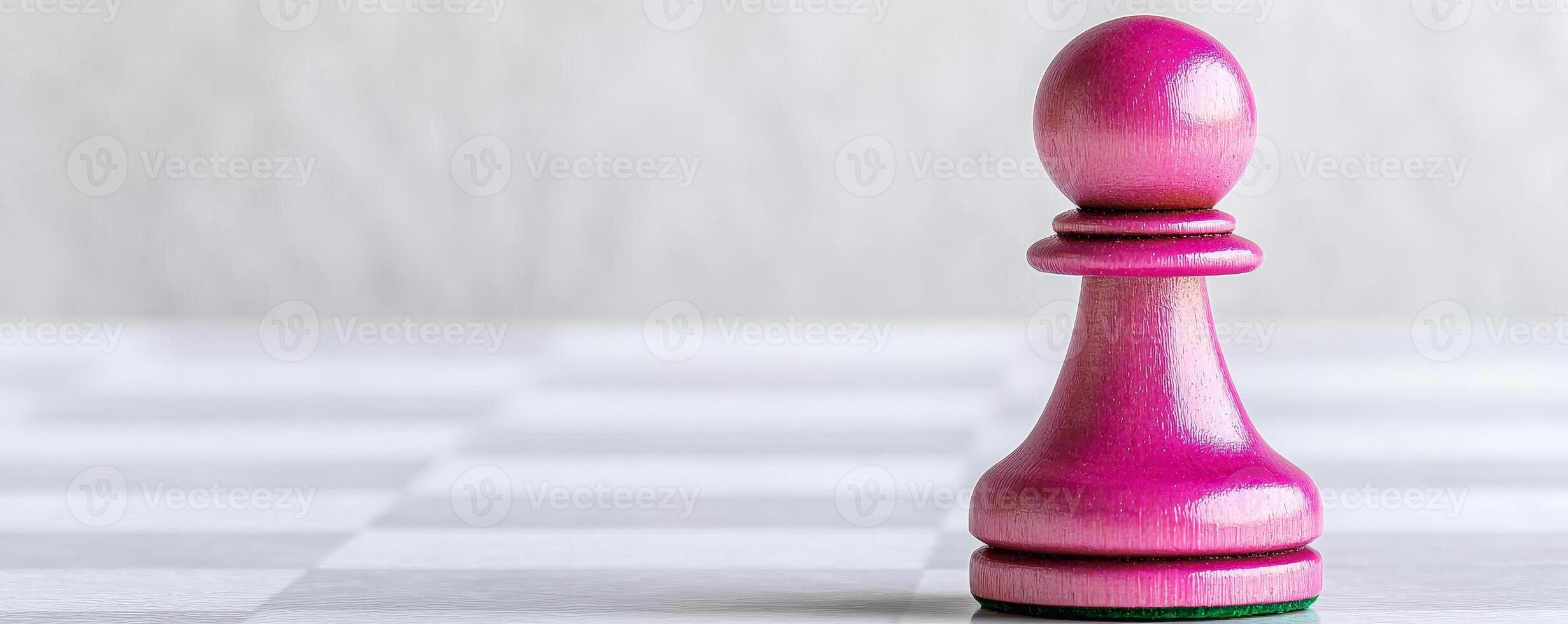 A single pink chess pawn stands prominently on a checkered board, symbolizing strategy and competition in the game of chess. photo