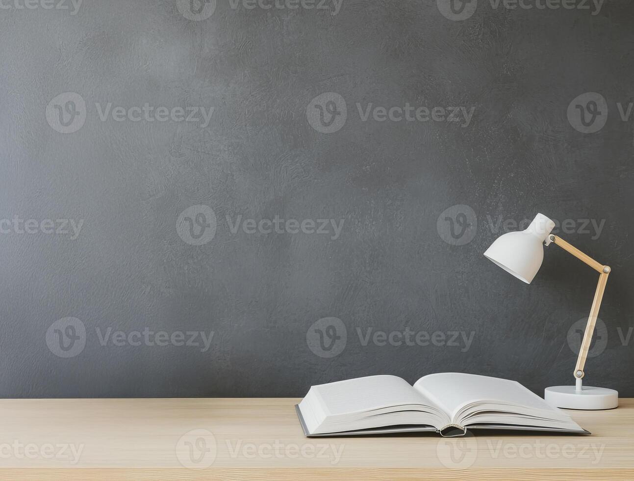 Higher education with students and policy concept. A minimal workspace featuring an open book and a desk lamp on a wooden surface against a gray wall. photo