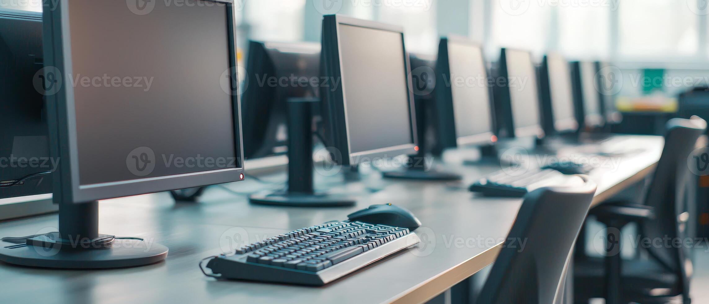 Higher education with students and policy concept. A row of desktop computers with keyboards in a bright, modern workspace. photo