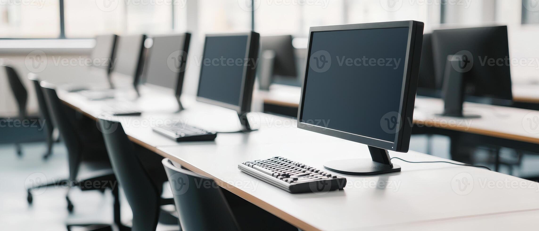 Higher education with students and policy concept. Modern office space featuring rows of computers on desks in a well-lit environment. photo