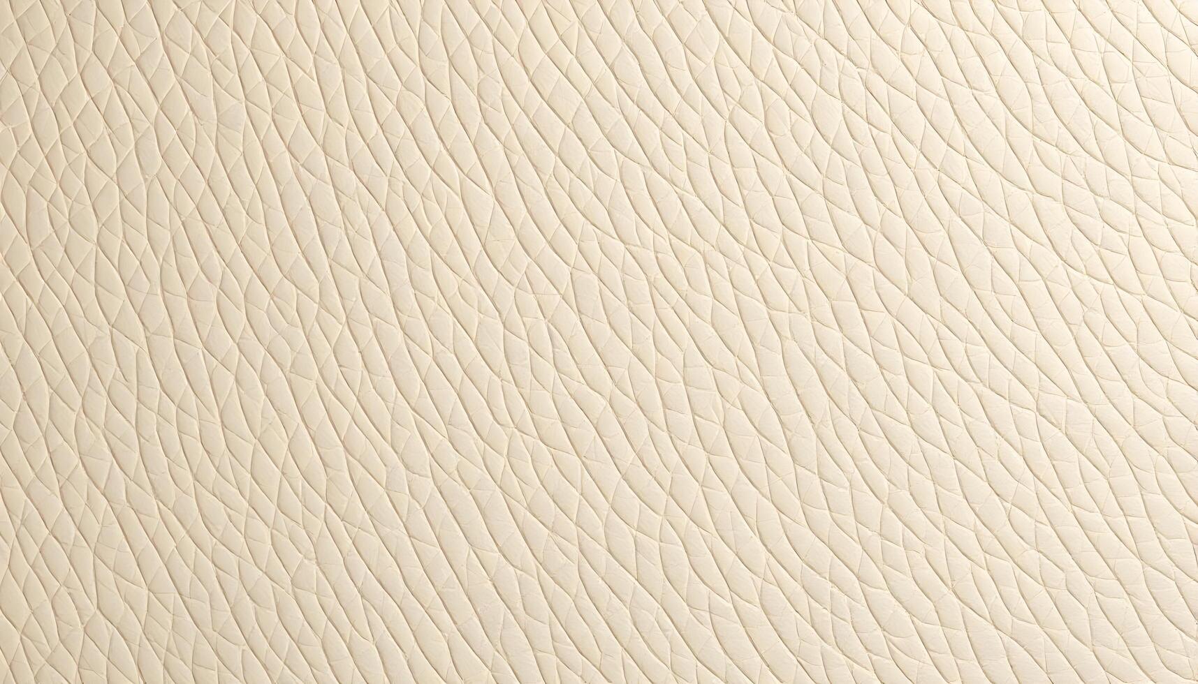 Soft beige leather grain texture background with a uniform appearance, highlighting the fine grain under bright light, giving it a smooth and polished look photo