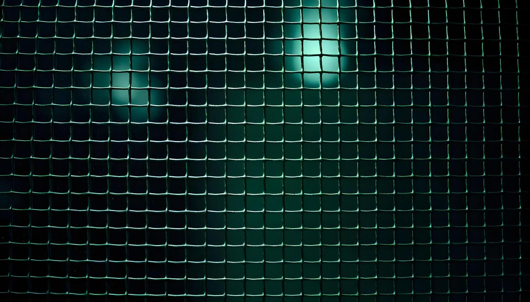 Textured metal mesh background under dim ambient light, with a focus on the fine details of the weave and a slight greenish tint photo