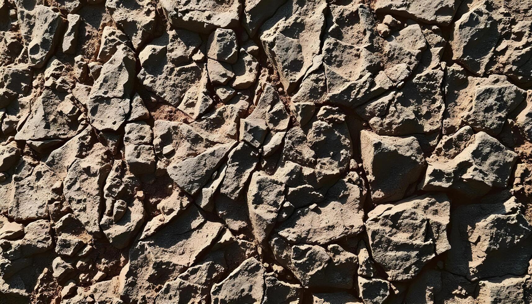 Rough, rocky surface with irregular, jagged shapes and textures, appearing to be a natural stone or rock formation photo