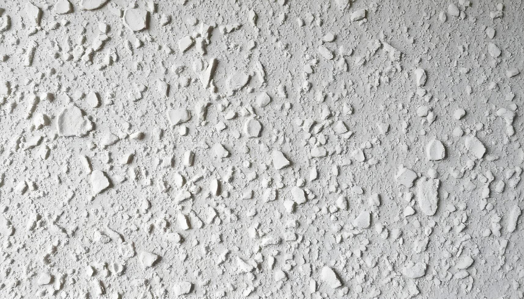 Textured white wall surface with irregular patterns and bumps photo