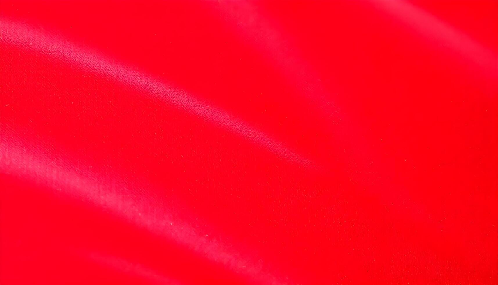 Vibrant red velvet texture with soft glossy finish and distinct creases photo