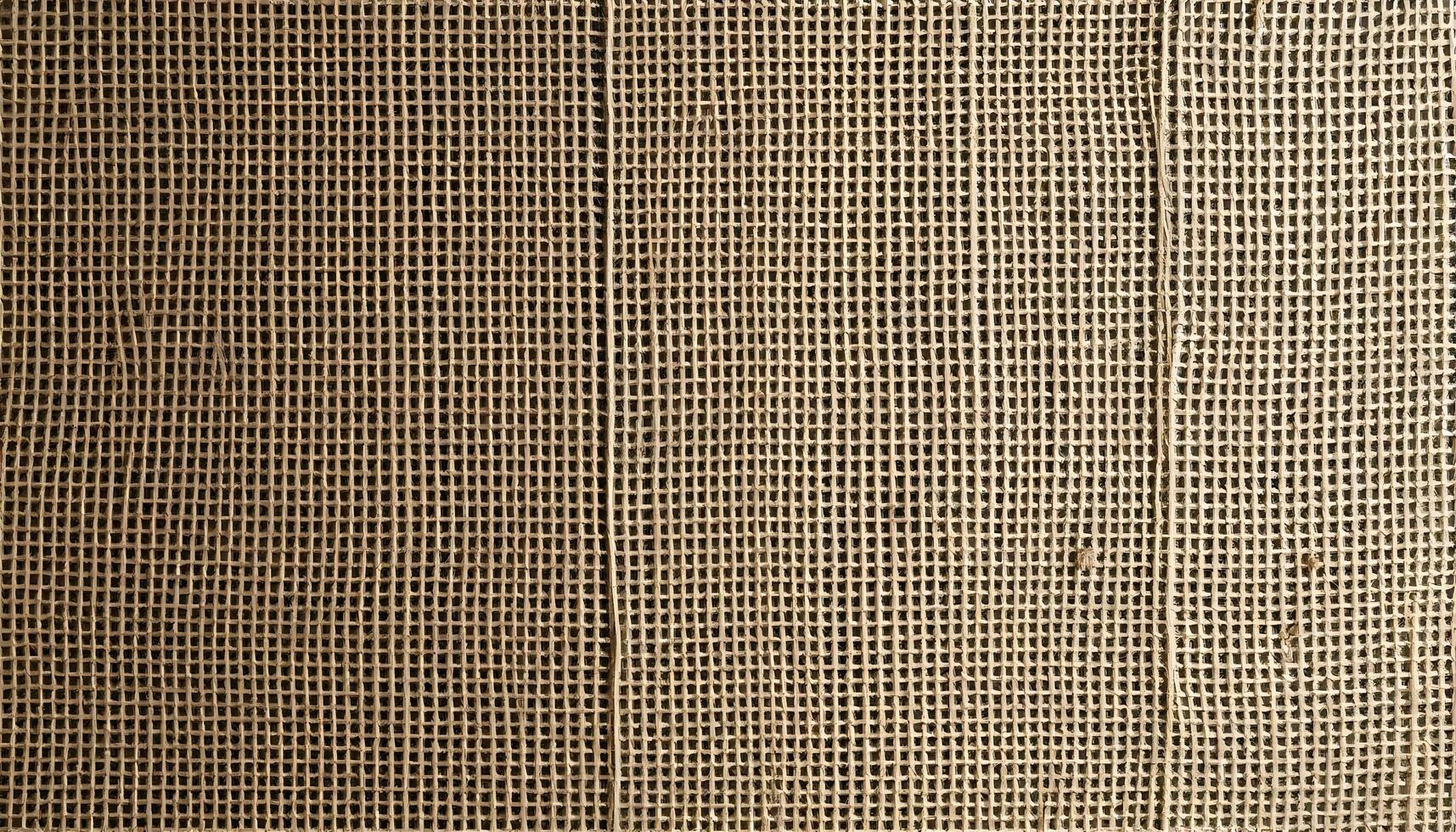 Burlap texture with intricate weave patterns, natural color variations, and soft shadows photo