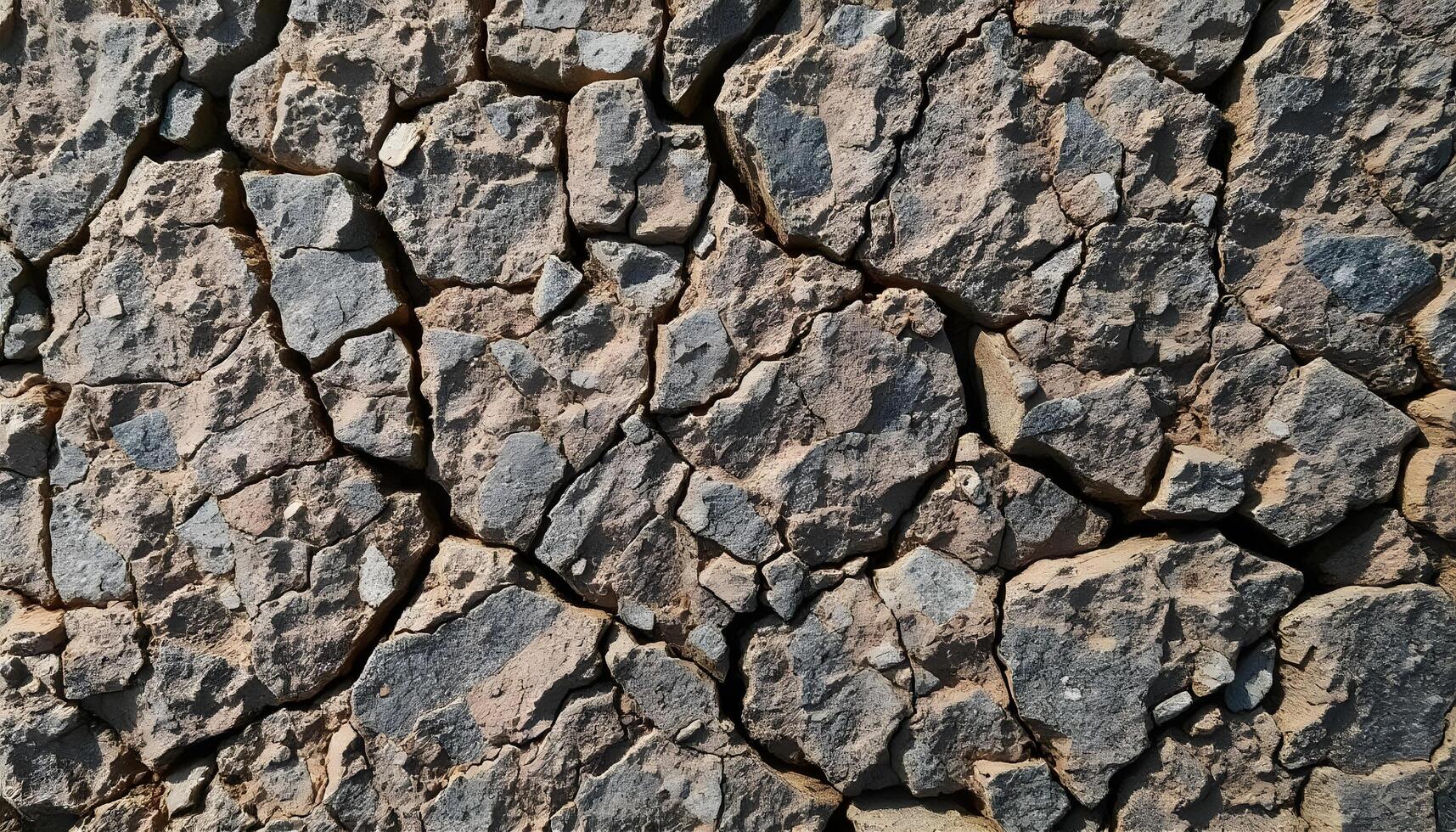 Rough stone texture in gray and brown with intricate natural imperfections photo