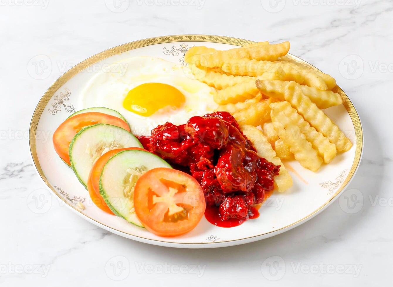 Spicy Meat with Fries, Sunny Side Up Egg, fresh cucumber and tomato slices served in plate isolated on marble background side view of singapore breakfast food photo