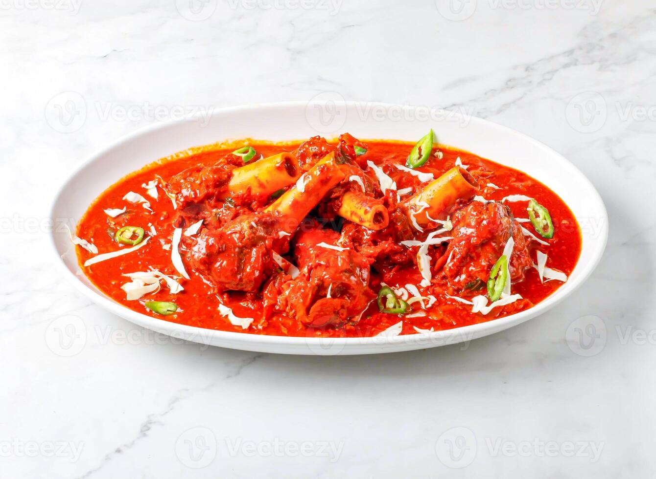 Mutton Rogan Josh with tomato gravy served in plate isolated on marble background side view of singapore food photo