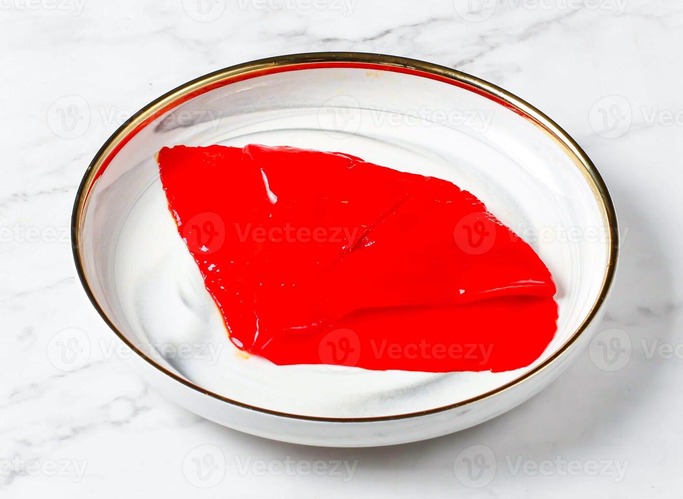 Squid with red sauce served in plate isolated on marble background side view of singapore food photo