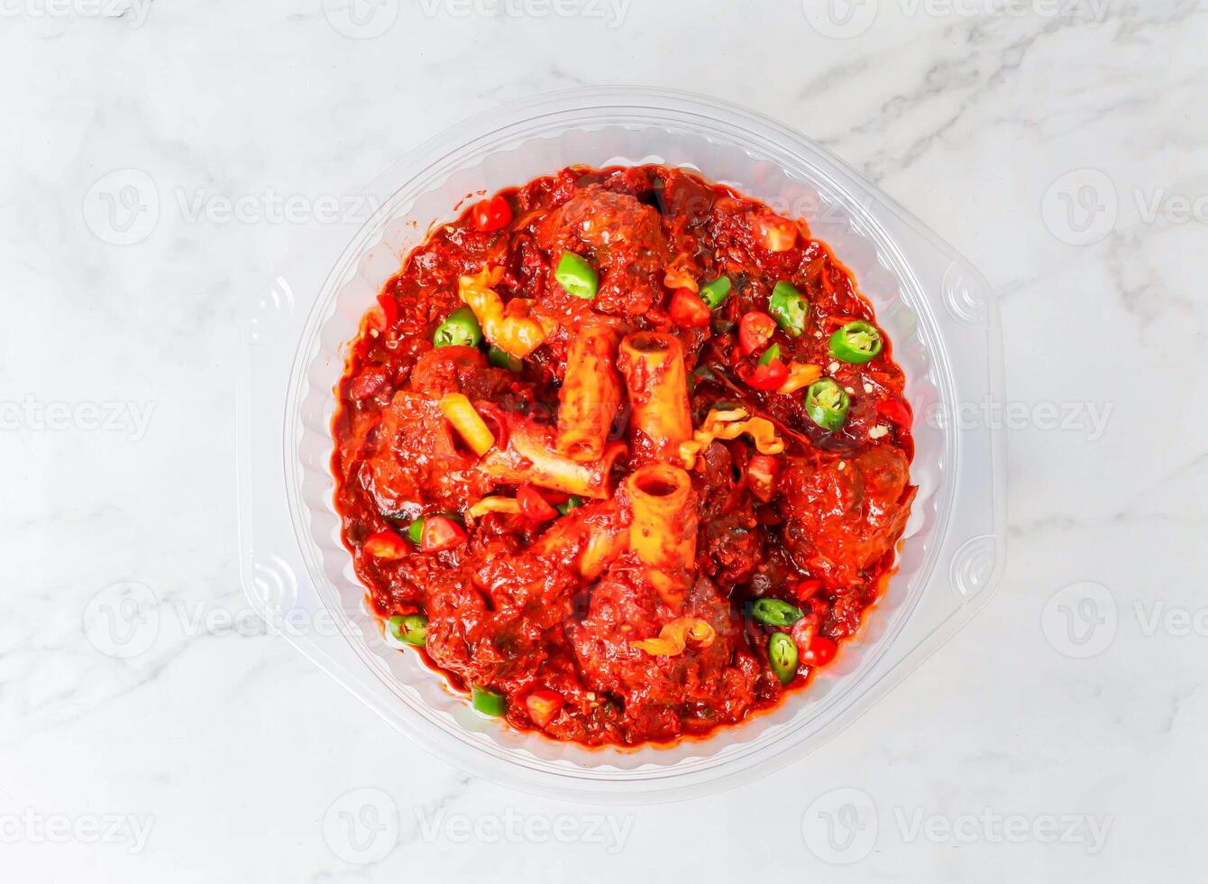 tulang tub masala or Spicy Mutton Curry with Green Chilies served in bowl isolated on marble background top view of singapore food photo