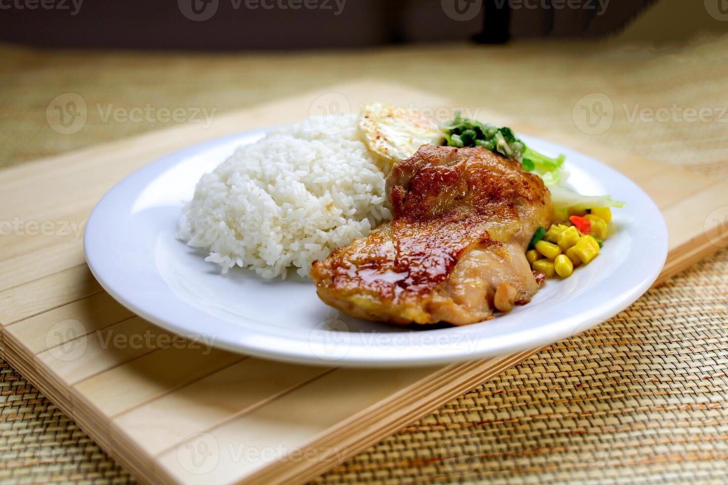 Scallion Chicken Chop with Rice, Egg Omelette and sou sauce served in plate isolated on table closeup side view of Hong Kong food photo