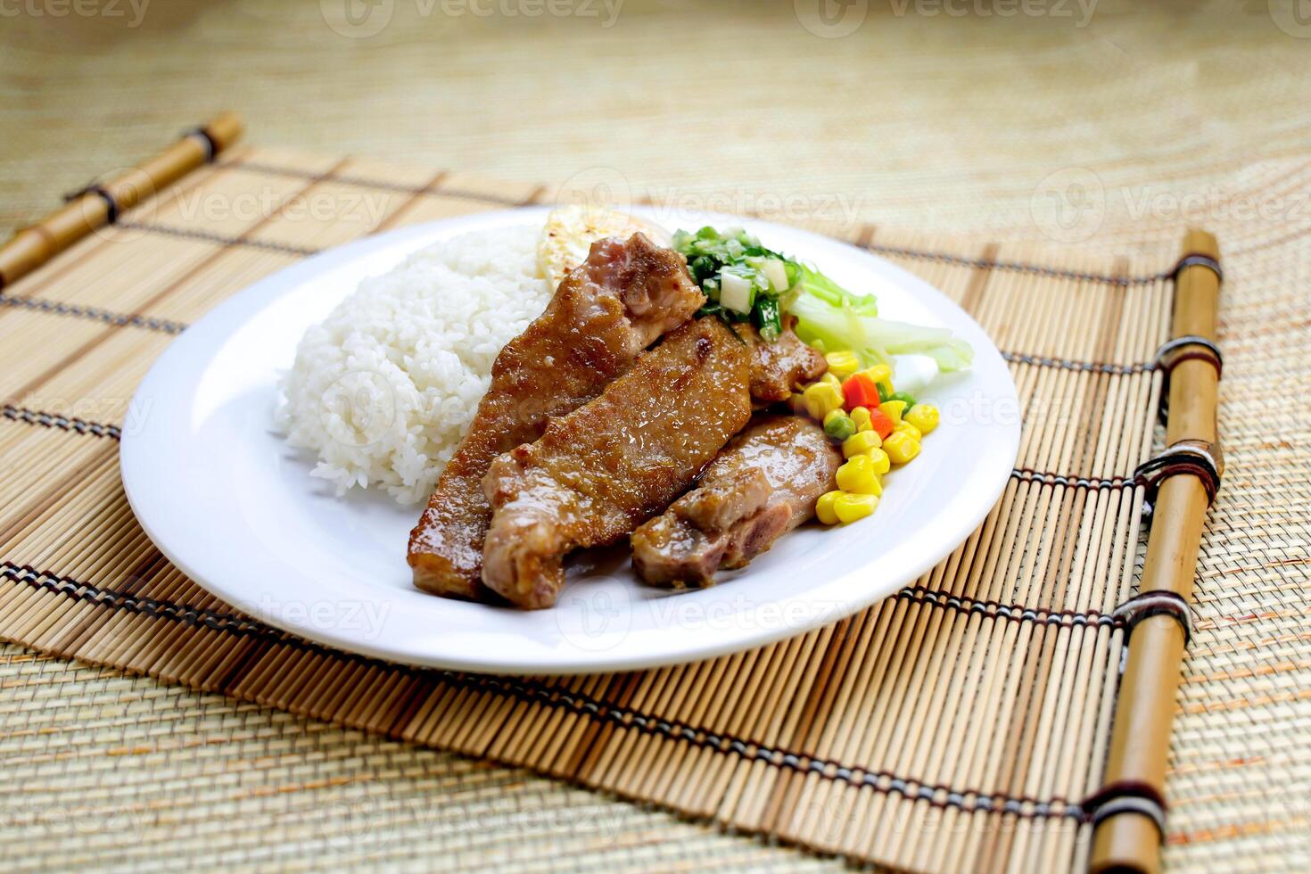 Scallion Pork Chop with Rice, Egg Omelette and sou sauce served in plate isolated on table closeup side view of Hong Kong food photo