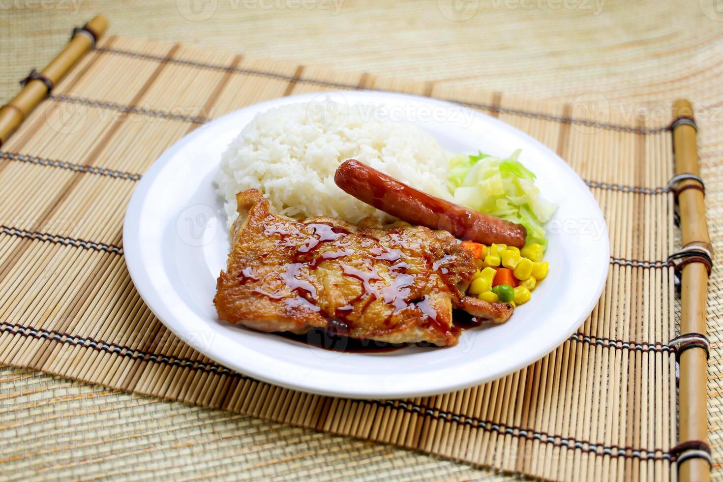Japanese style sauteed chicken with, sausage, rice and vegetables served in plate isolated on table side view of Hong Kong food photo