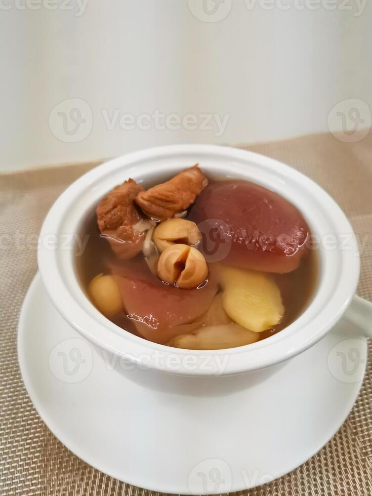 Pork Shank Soup with Figs and Apples served in broth isolated on background side view of Hong Kong food photo