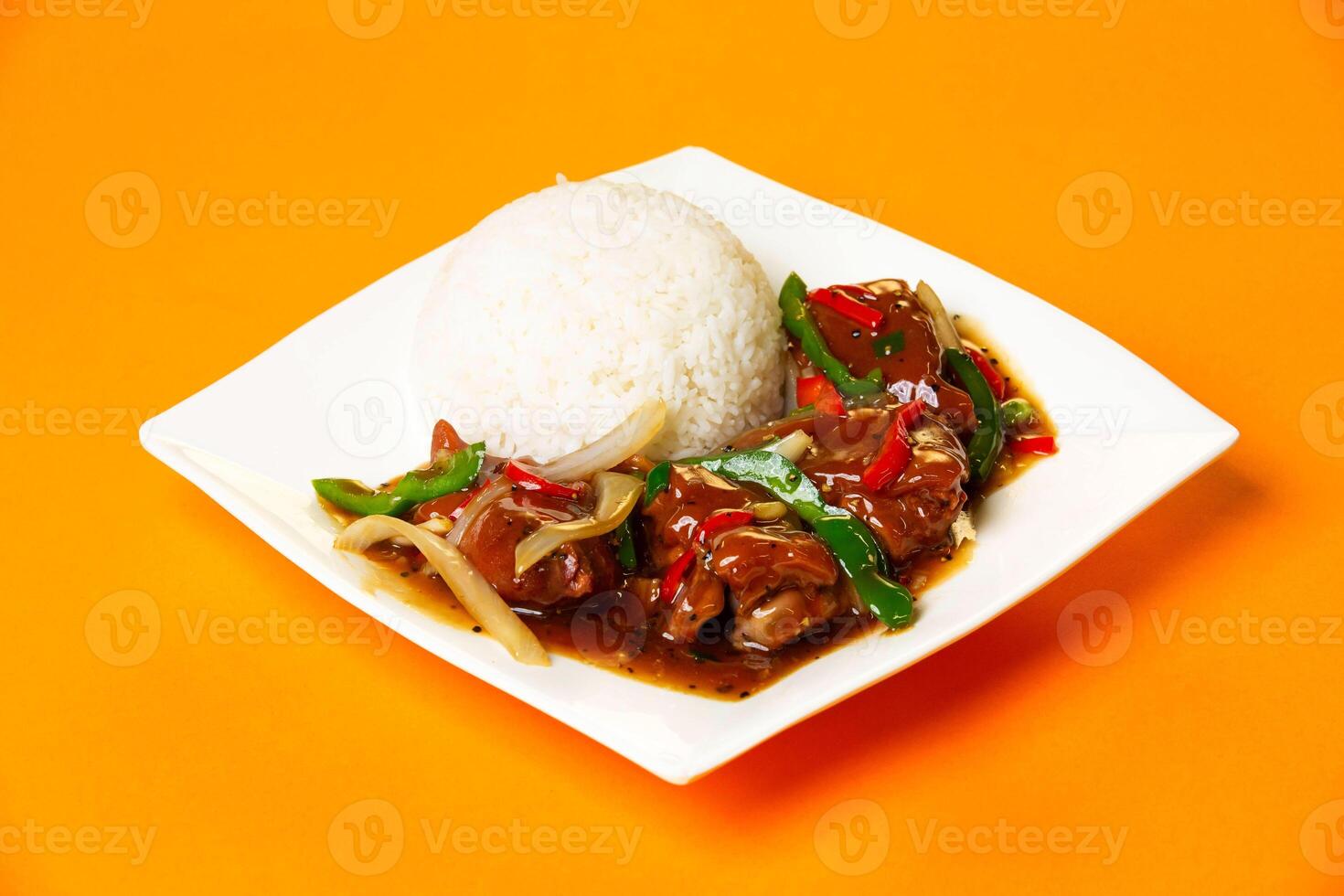 Black Pepper Pork Knuckle with Rice served in plate isolated on orange background side view of hong kong food photo
