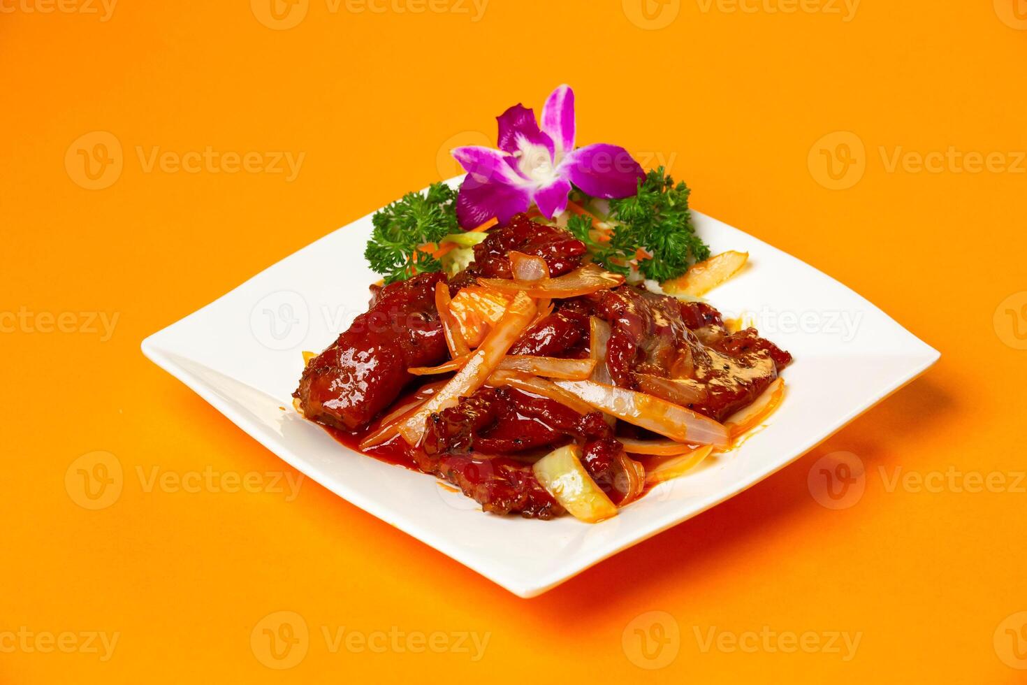 Chinese Beef Tenderloin with onion served in plate isolated on orange background side view of hong kong food photo
