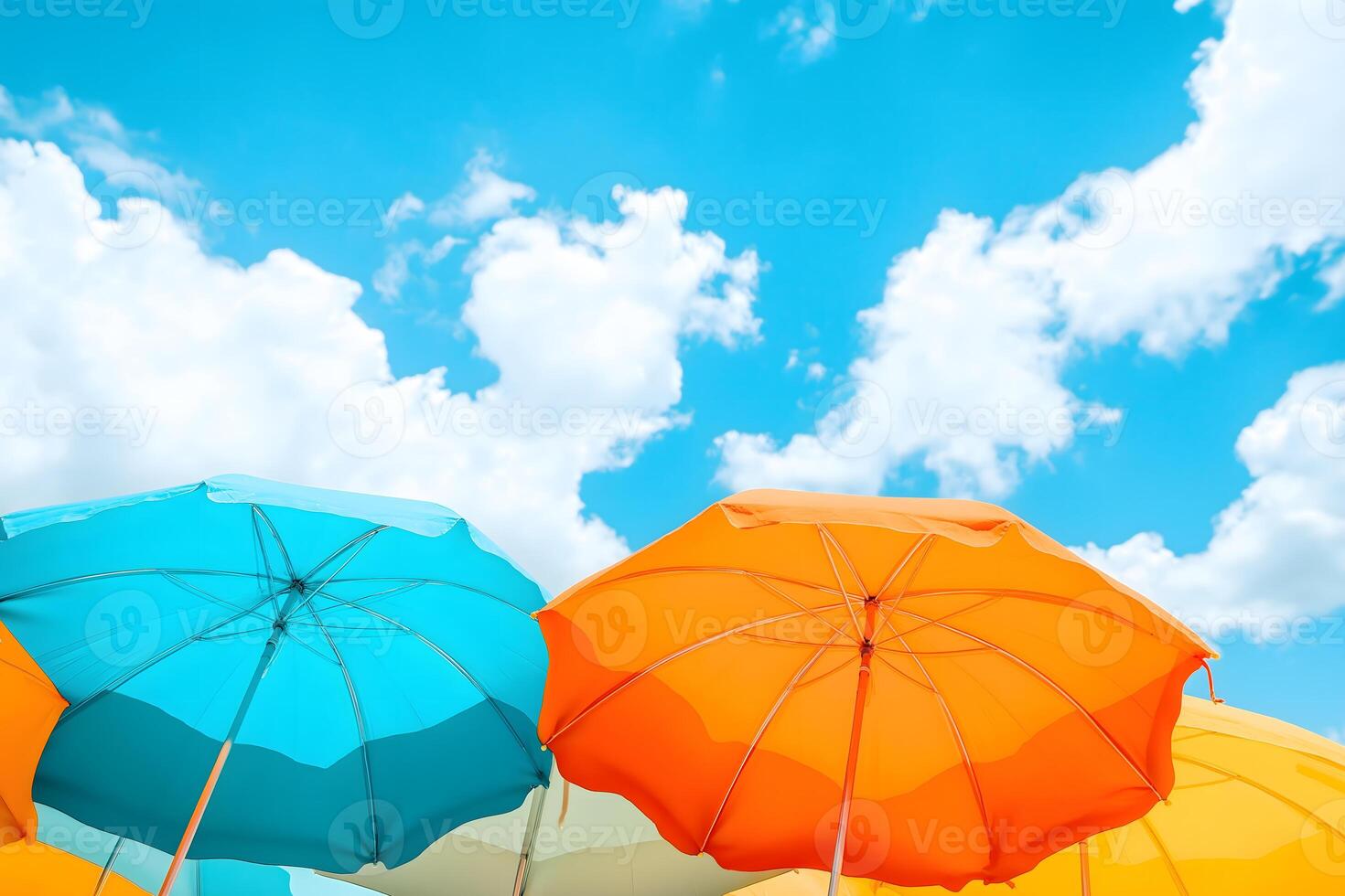 A group of colorful umbrellas against a blue sky photo