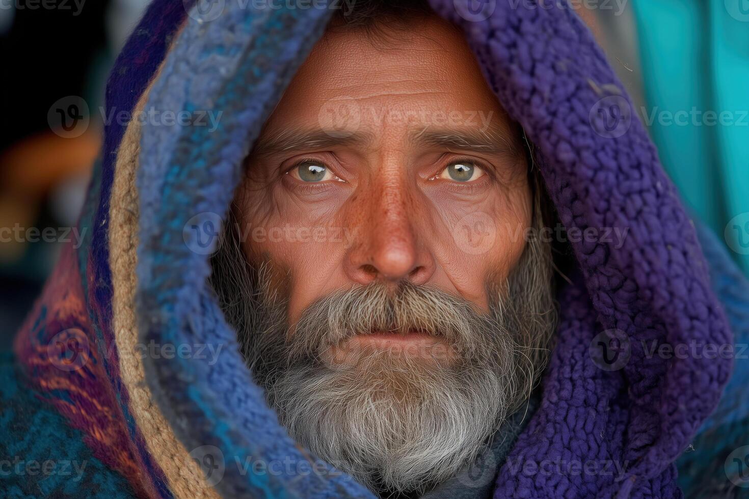portrait, look of an elderly houseless man wrapped in warm clothes photo