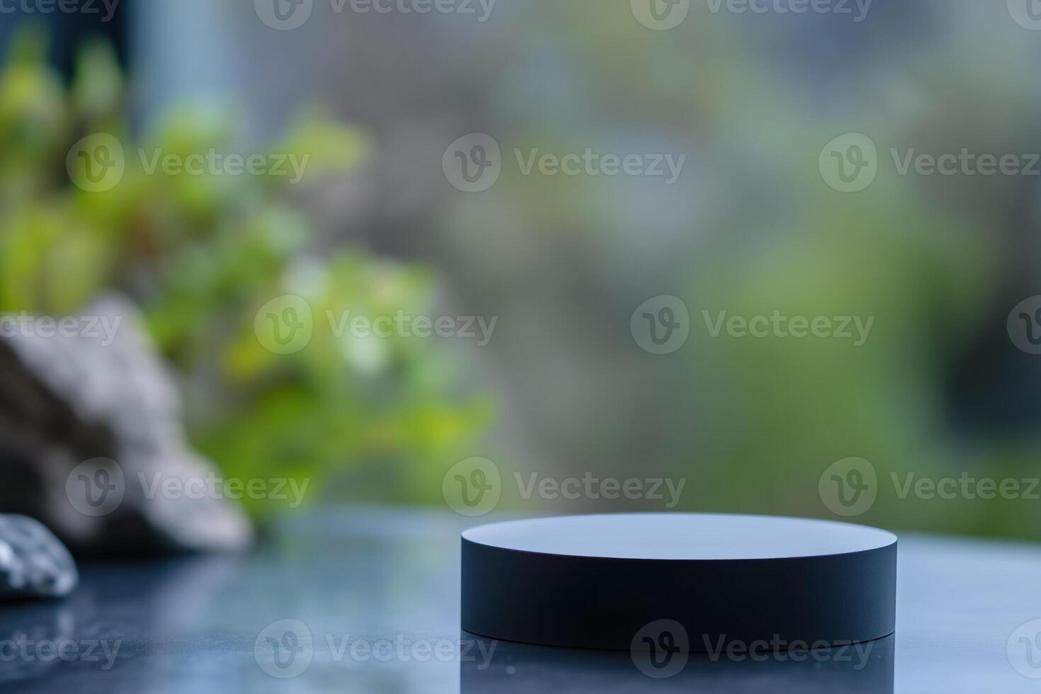 Blank black product stand in front of blurred background with copy space photo