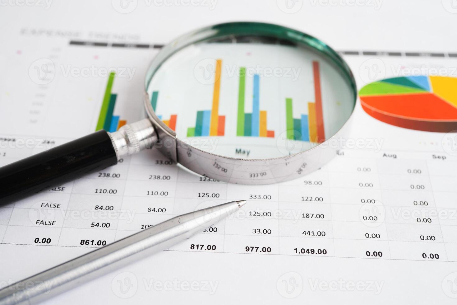 Magnifying glass on charts graphs paper. Financial development, Banking Account, Statistic, Investment photo