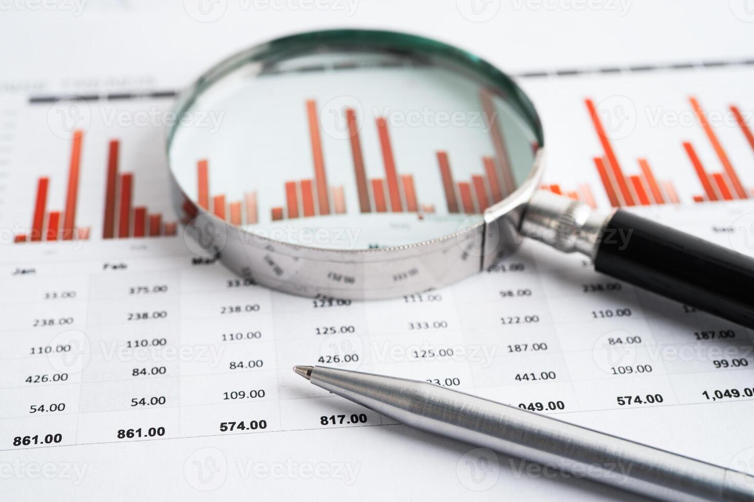 Magnifying glass on charts graphs paper. Financial development, Banking Account photo