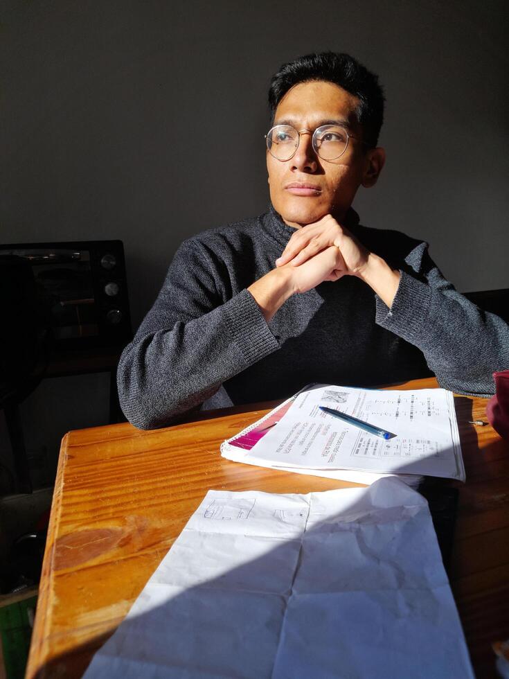 latino handsome Attractive young man studies deeply a difficult subject for college photo