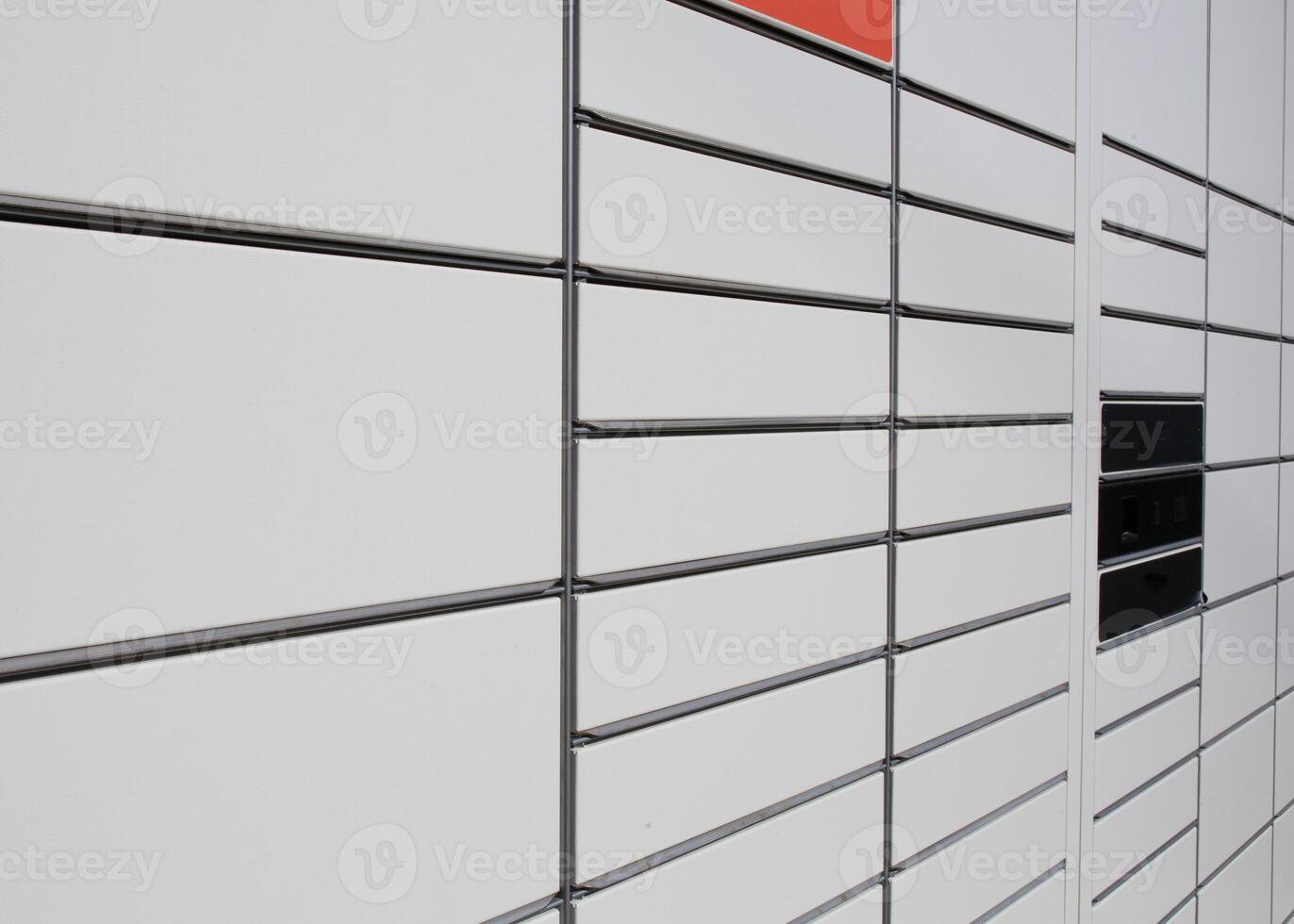 Modern parcel locker with closed compartments. Metal construction for convenient storage and package pickup. Concept of online shopping, automated delivery photo