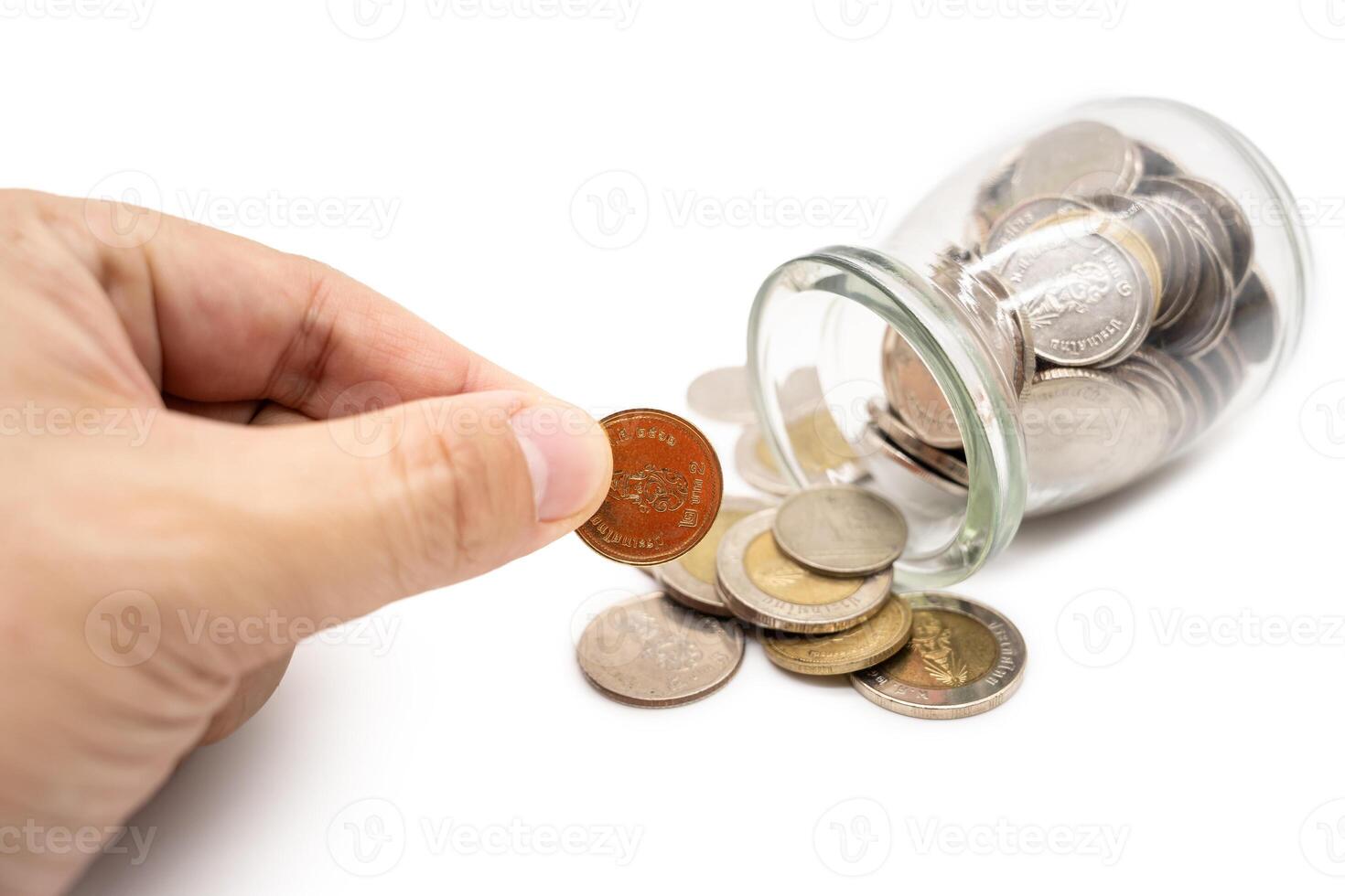 Thai Baht Coins spilled out of jar glass isolated on white background, saving for future, Investment business concept. photo