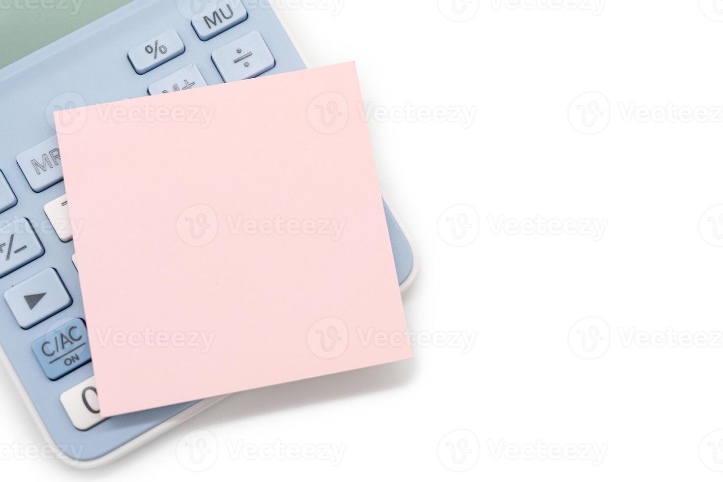 Blank Pink Sticky note with calculator background. Financial data analyzing. Copy space for text on sticky note. isolated on white background. photo