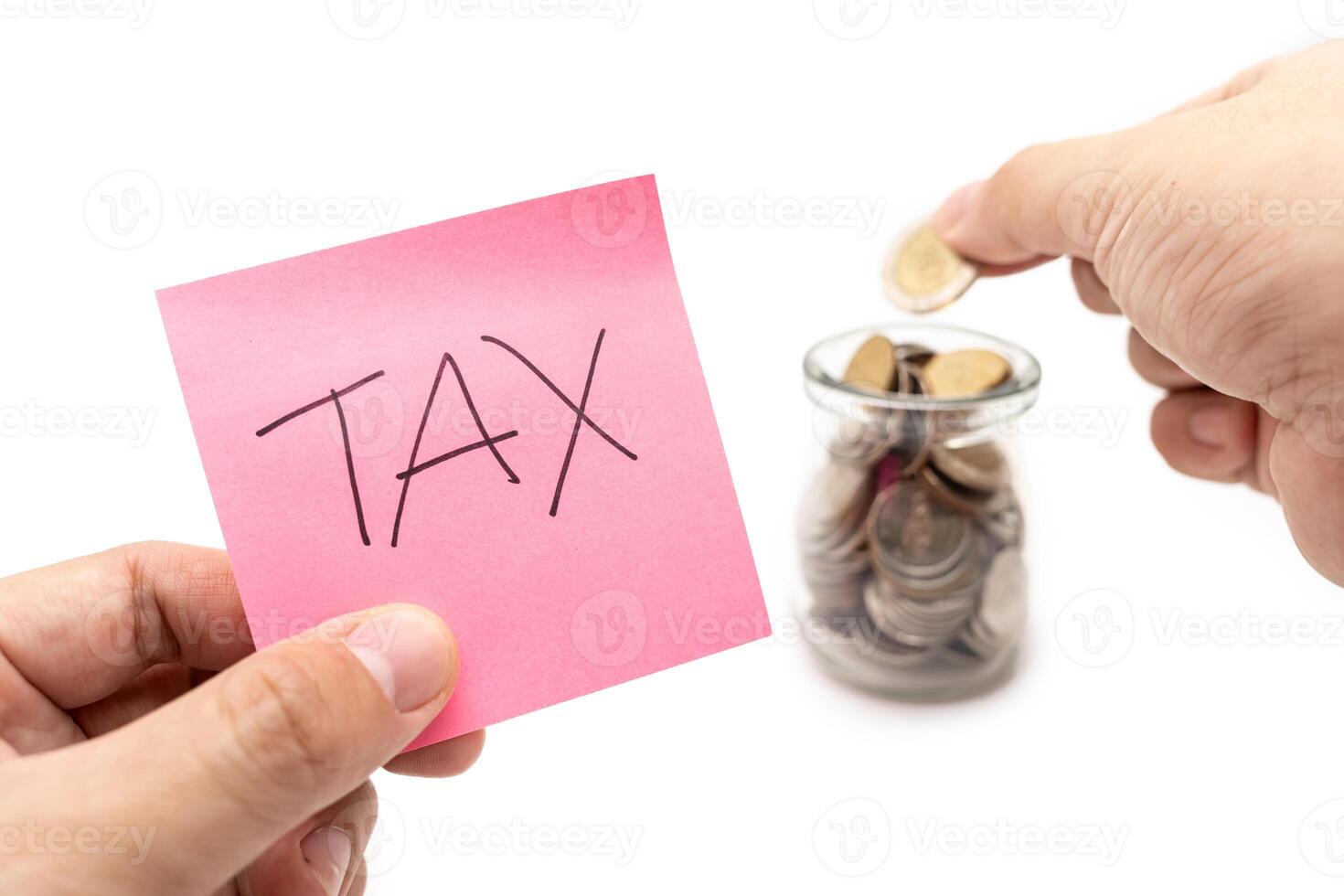 Saving money concept with TAX text on pink sticky note. placing a coin into a jar. isolated on white background. photo