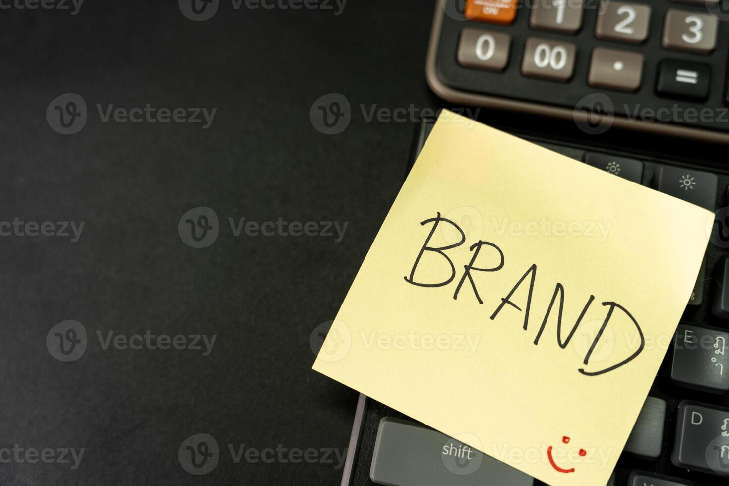 BRAND text with yellow sticky note on keyboard. Build your Brand. Brand building, success, business. Copy Space. photo