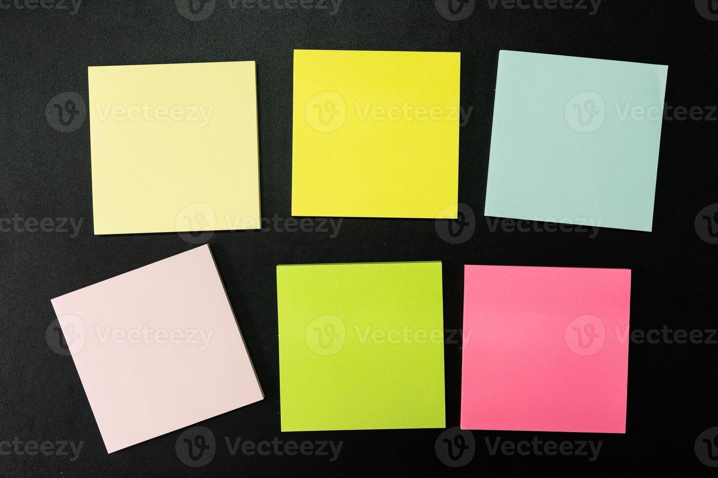 Blank colorful sticky note isolated on black background. Copy space photo