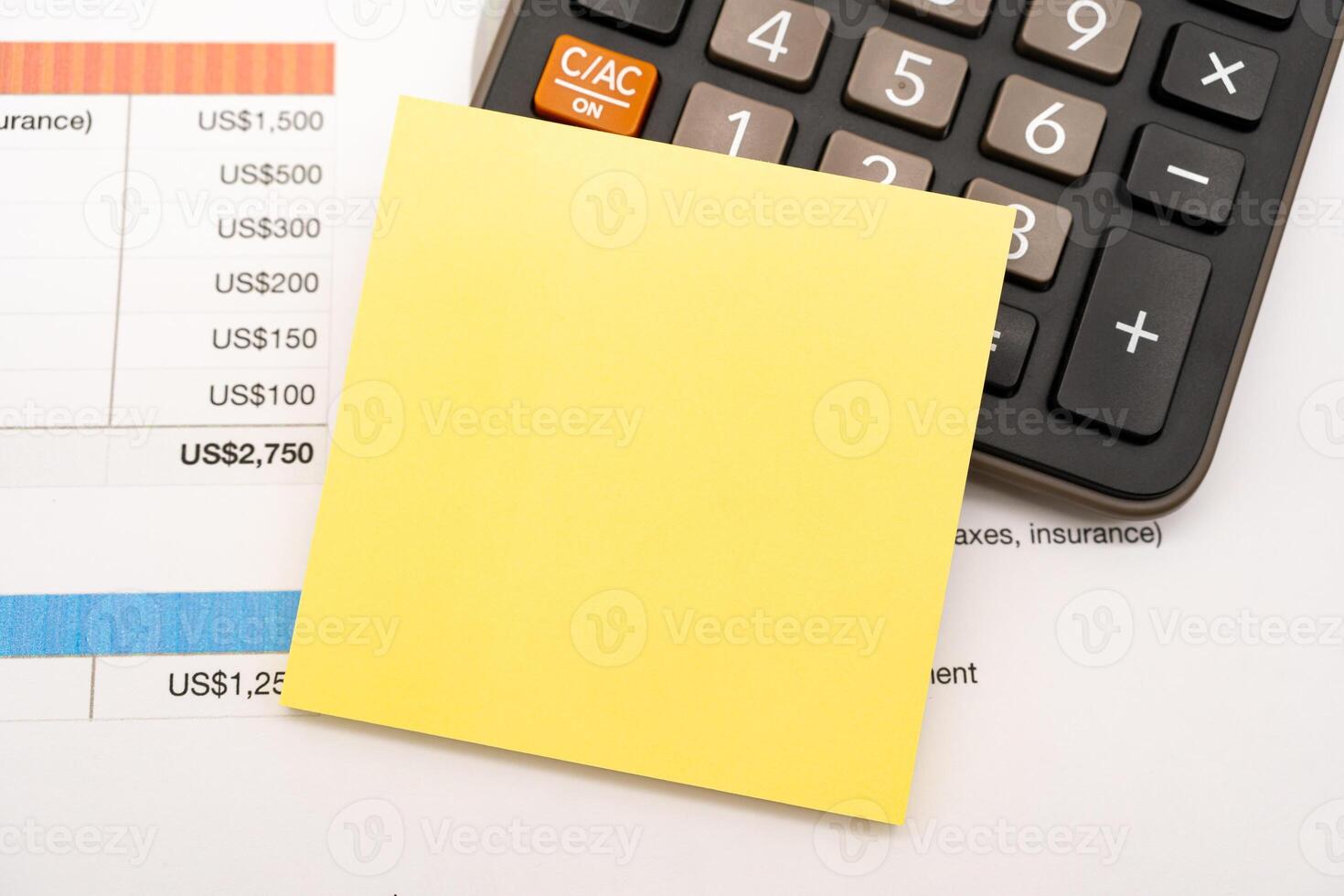 Blank Sticky note with calculator background. Financial data analyzing. Working on desk with using calculator photo