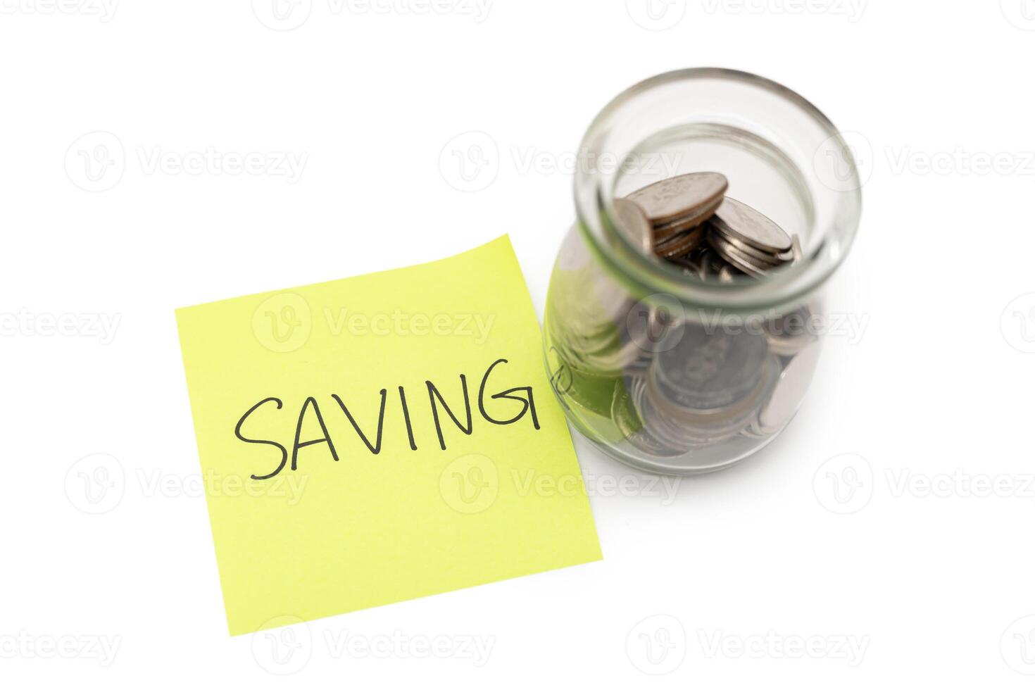 SAVING text with sticky note and Coins in glass money jar isolated on white background, financial concept. Saving money concept. photo