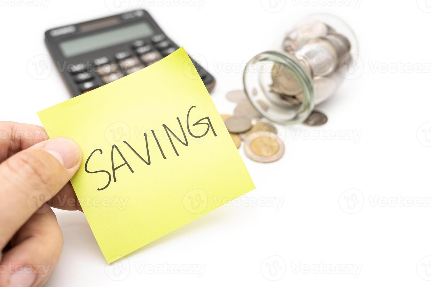 SAVING text with sticky note, calculator and Coins in glass money jar isolated on white background, financial concept. photo