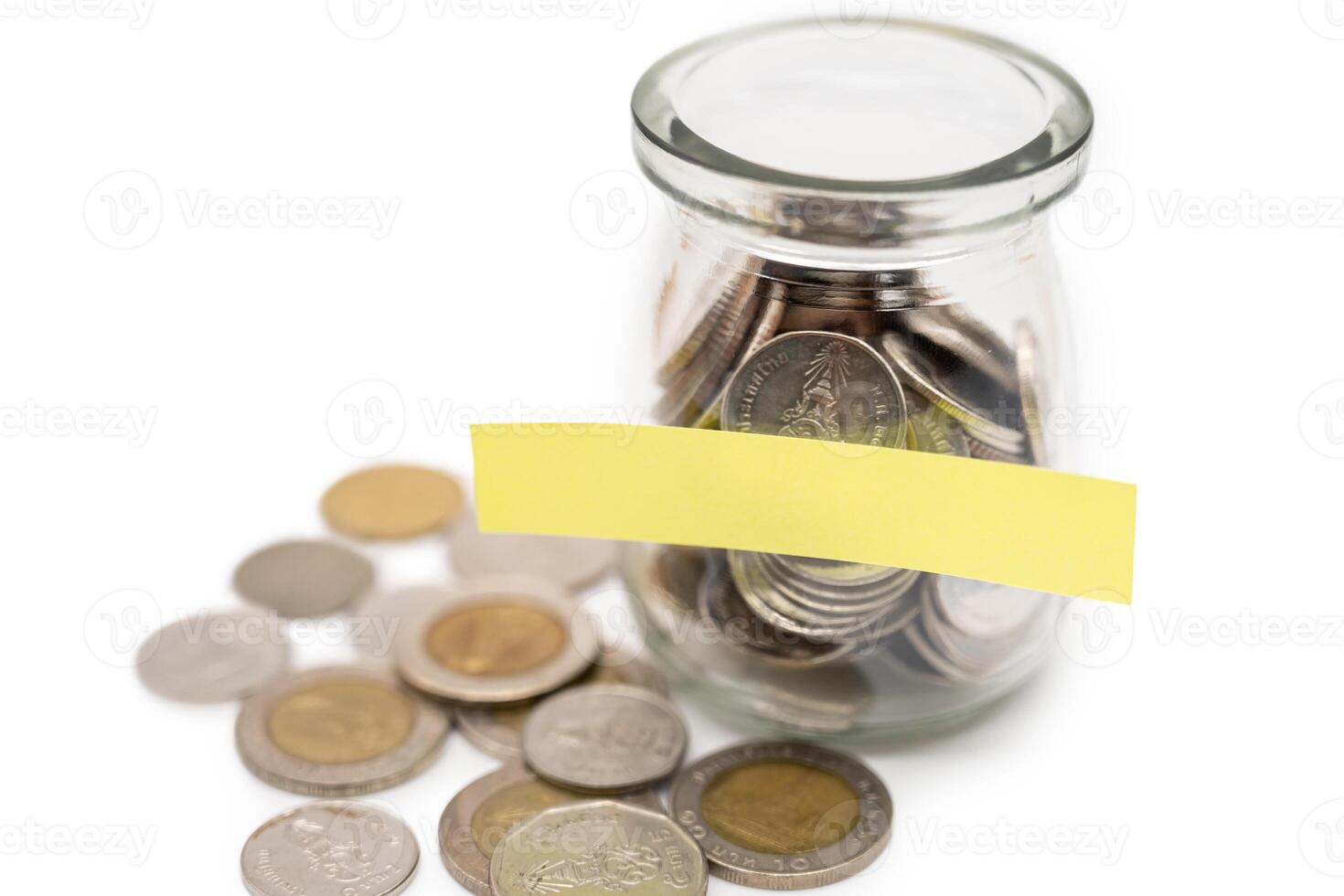 Coins in glass money jar with blank label for text, financial concept. photo