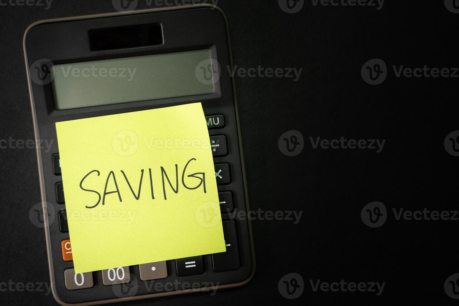 SAVING text with sticky note on calculator. financial concept. Saving money concept. Retirement concept. Pension calculation concept. Copy space. photo