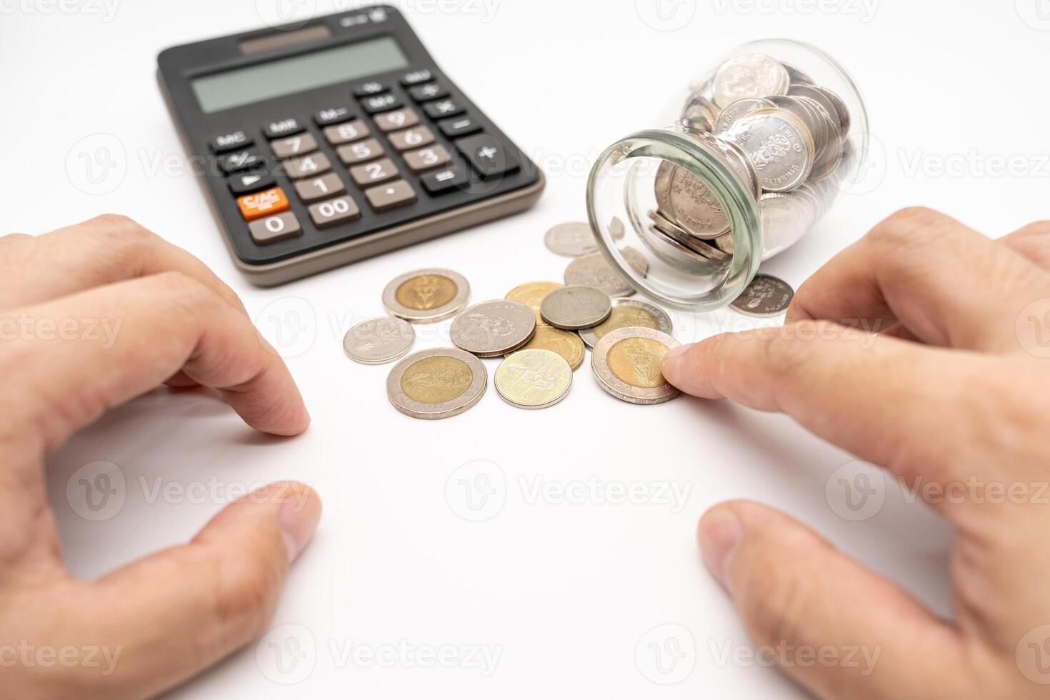Thai Baht Coins spilled out of jar glass and Calculator isolated on white background, saving for future, Investment business concept. Business Concept. photo