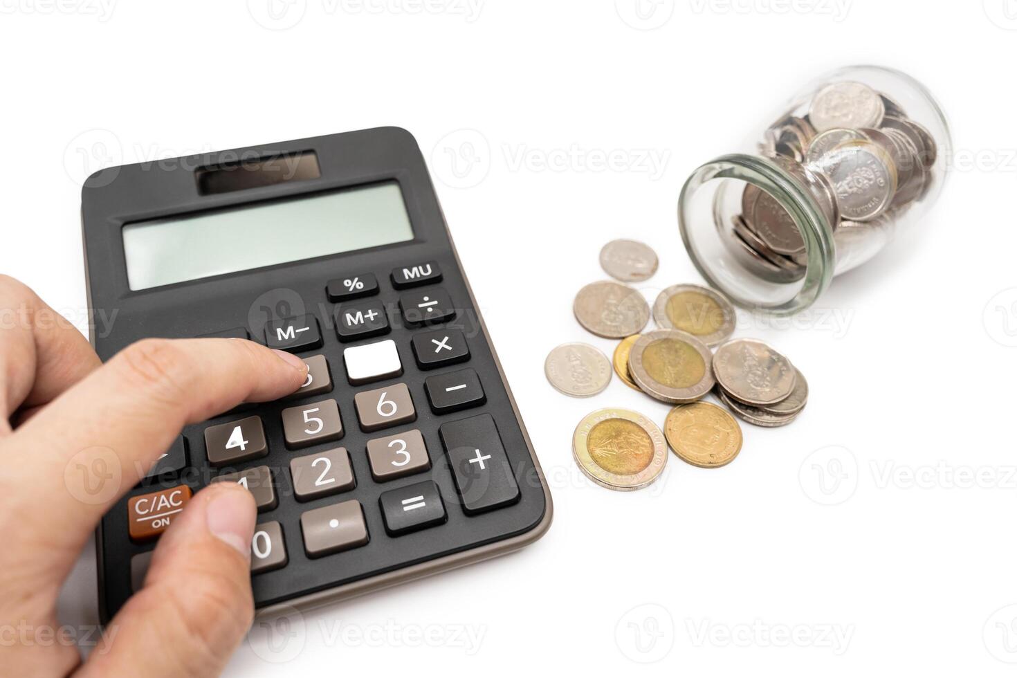 A finance with a jar of Baht coins and Calculator. Financial Settlements, Household Budget, Taxes, Financial Analysis, Economic and Business Concept. Isolated on white background. photo