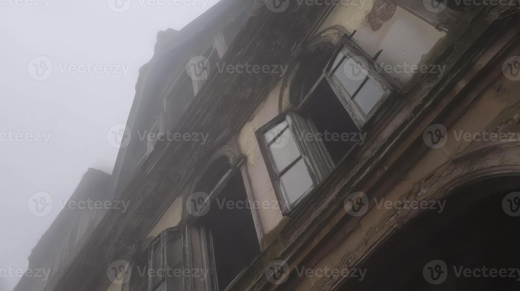 A building with windows and a foggy sky photo