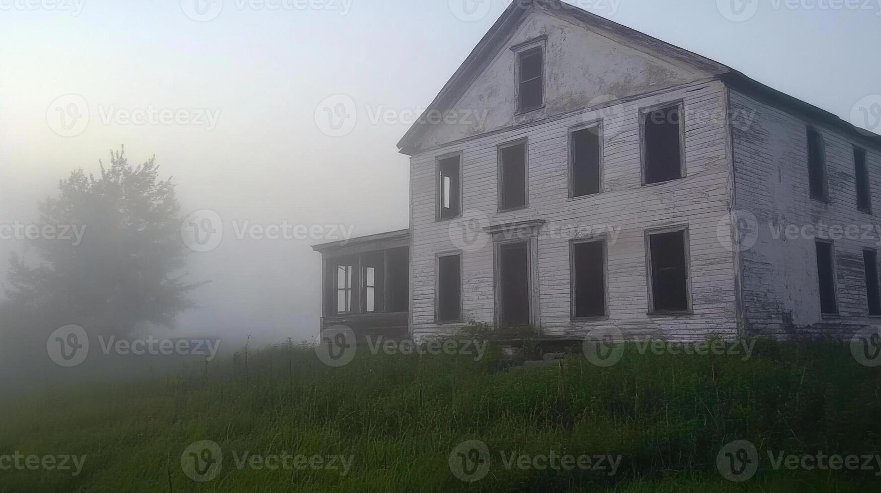 An old abandoned house in the fog photo