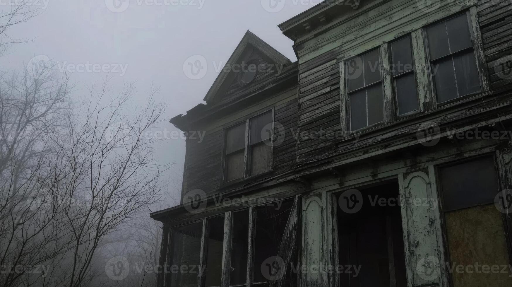 An old abandoned house in the foggy woods photo
