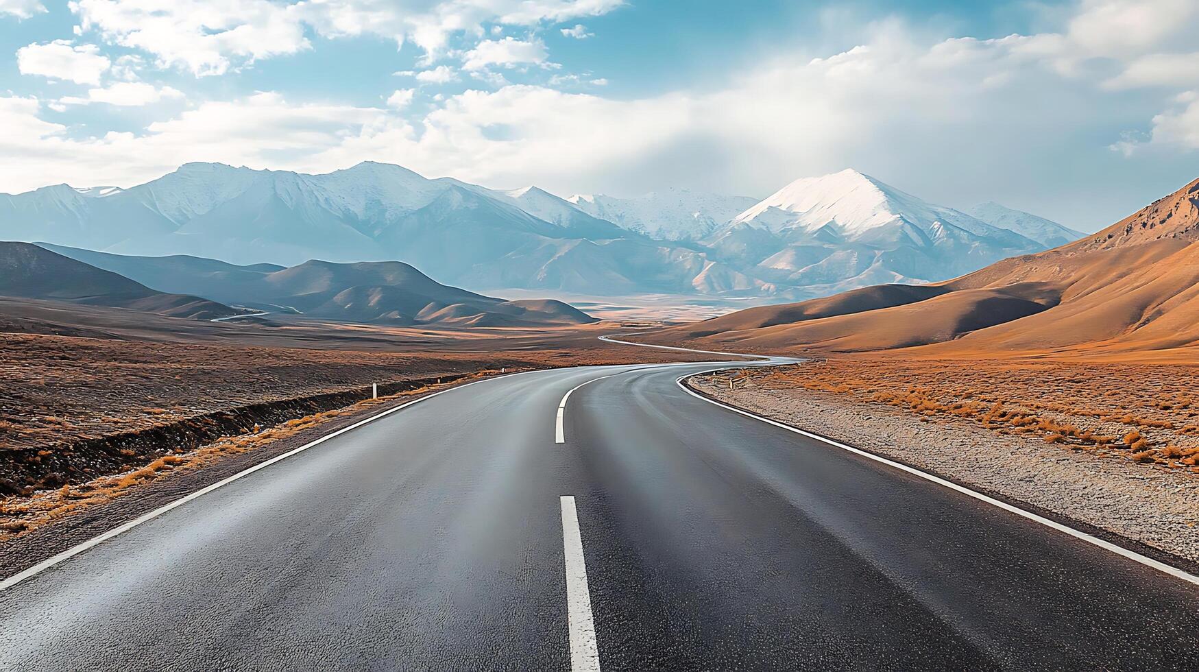 Tranquil Road Leading to Snow-Capped Peaks photo