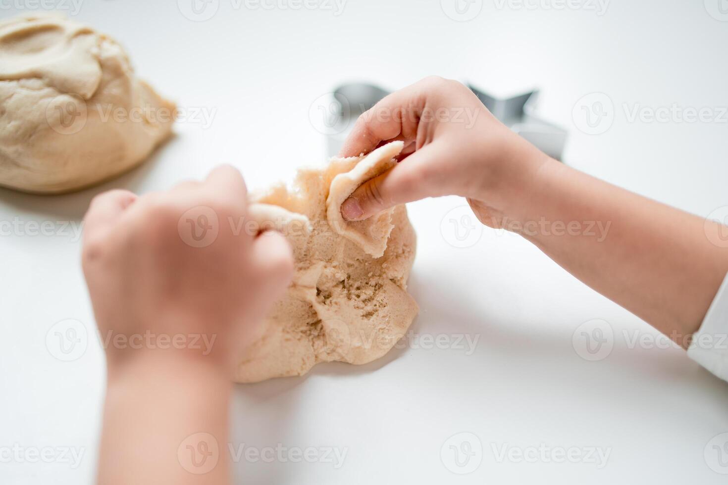 Child playing with play dough. Creative hands on activity for young caucasian kid photo