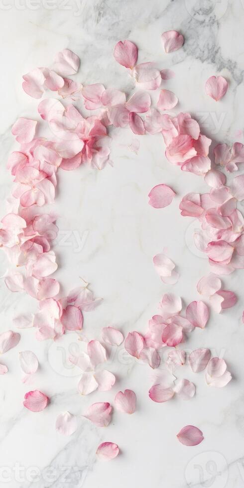 Elegant flat lay with scattered sakura petals on marble surface for spring design photo