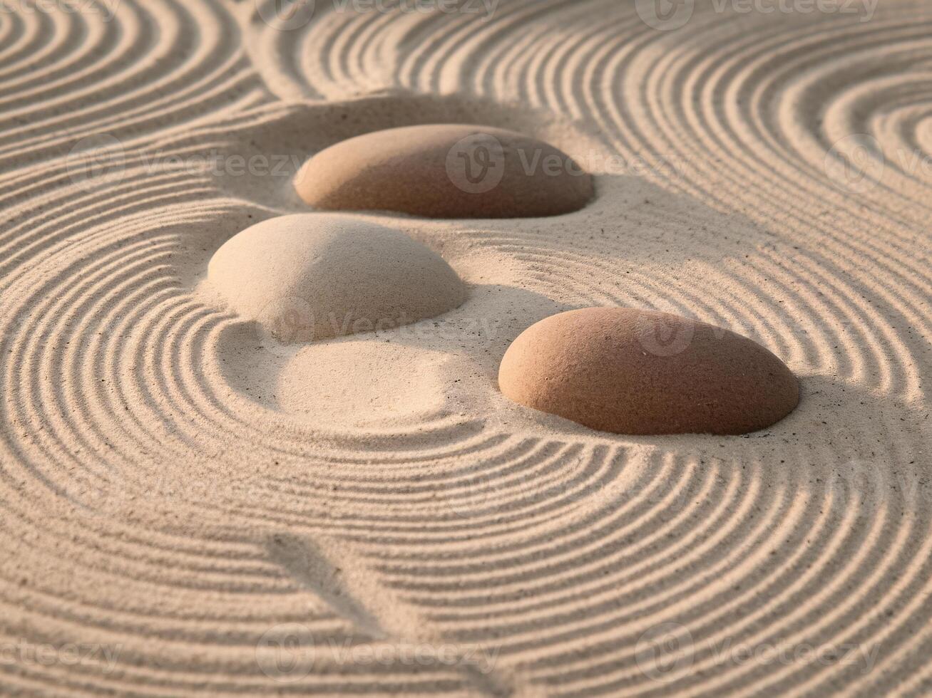 Three smooth stones rest in a tranquil zen garden of raked sand, creating a calm and meditative atmosphere. photo